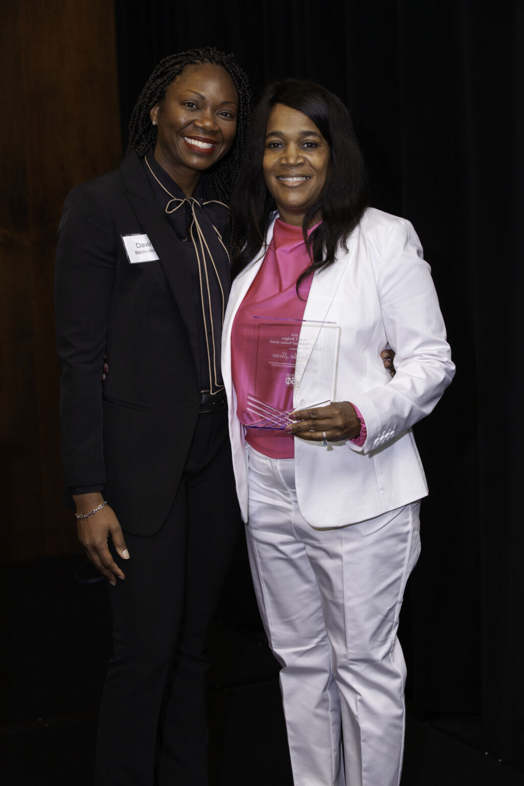 Davina Bodin-Woods with Pebbles Lucas (right) as she accepts the Mary Y. Bridgers Award for excellence in early childhood education at the CCSA annual breakfast on March 8th, 2024. 
